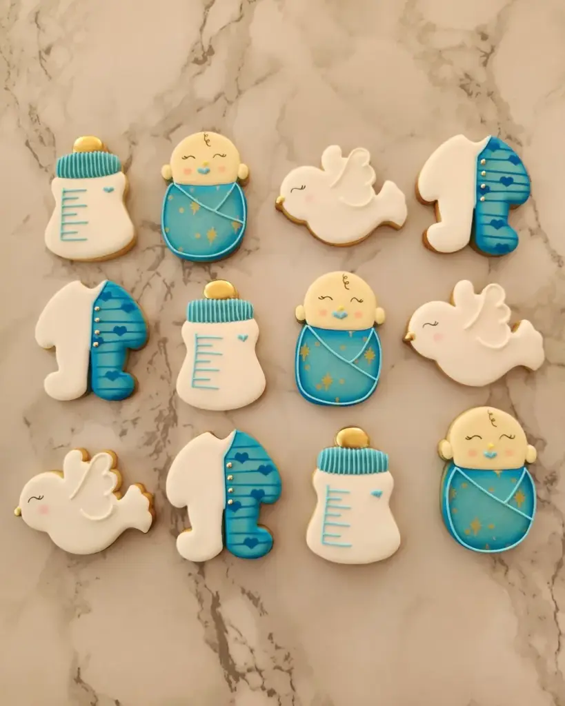 Galletas para baby shower de niño en verde azulado con bebés, mamaderas y palomas